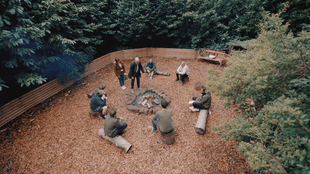 Still of a group therapy session at Delamere outside in the woods