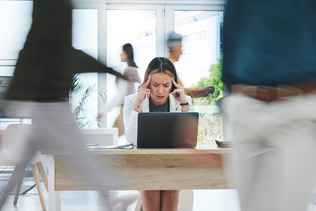 headache and stressed woman infront of laptop