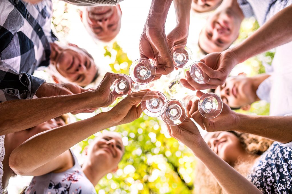 family celebrating with drinks, camera underneath