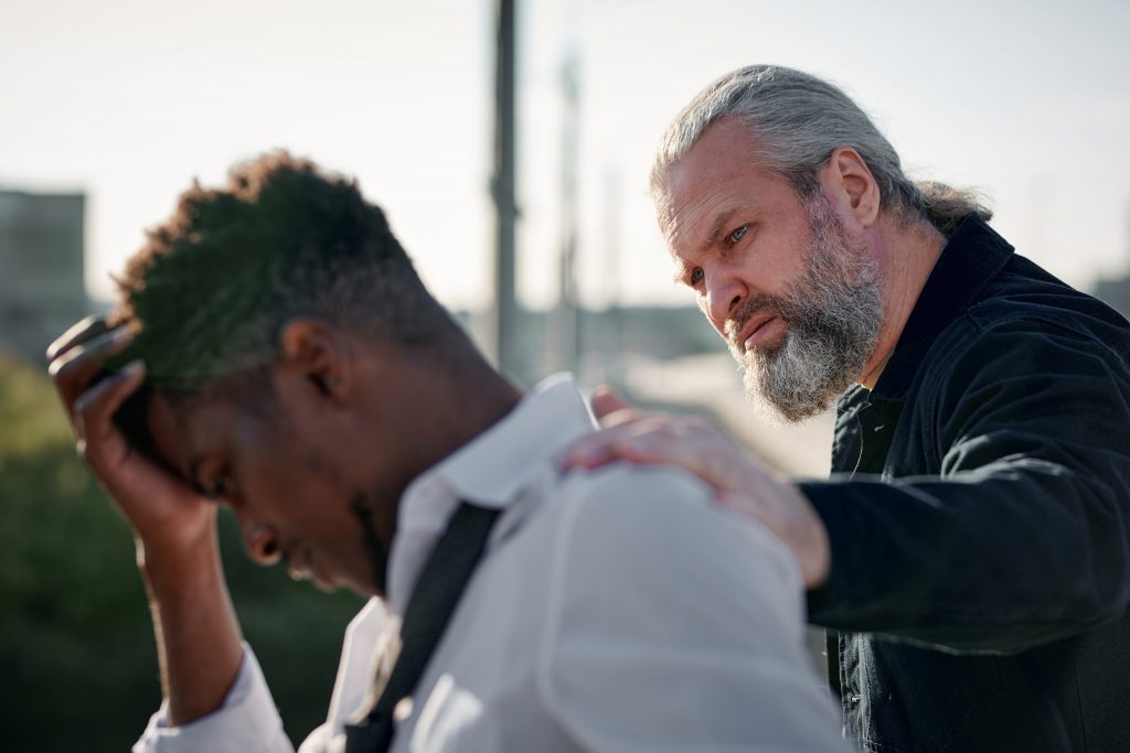 man consoling another man