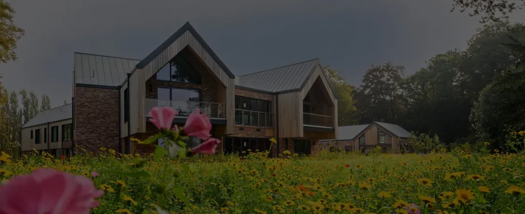 darkened image of gardens at Delamere Health