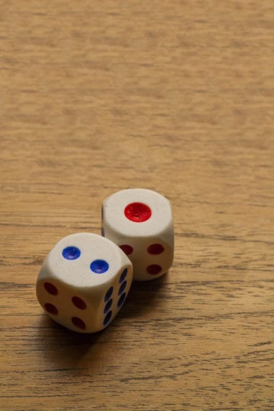 two dice on a wooden table